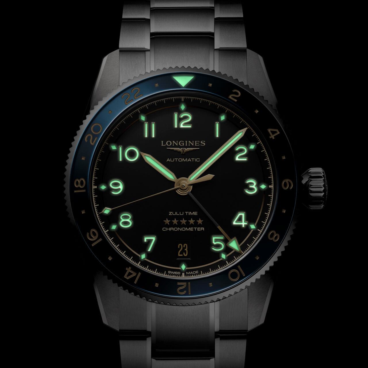 Watch in low-light setting showing luminous dial markers and blue bezel image number 2